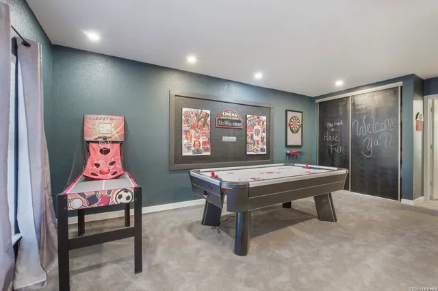 a room with pool table and windows