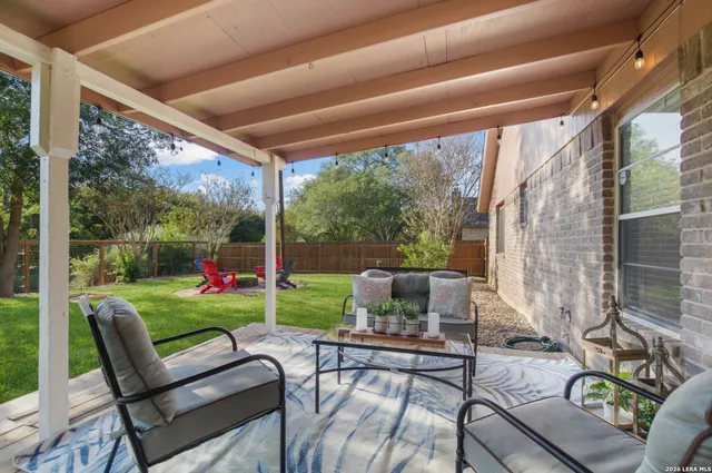 a view of a patio with couches chairs and a big yard