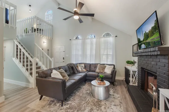 a living room with furniture and a fireplace