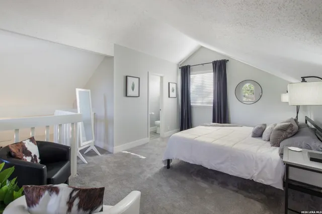 a bedroom with a bed and couch