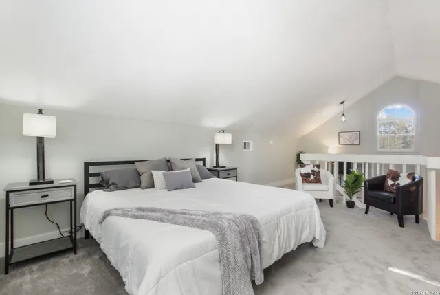a bedroom with a bed and a view of kitchen