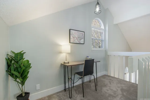 a view of a dining room with furniture and a potted plant
