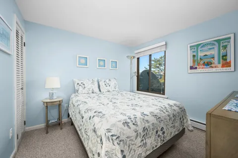 a bedroom with a bed and painting on the wall