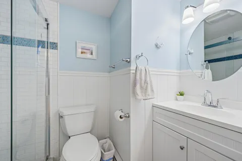 a bathroom with a toilet sink and shower