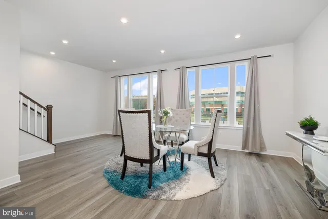 a kitchen with a table chairs refrigerator and cabinets
