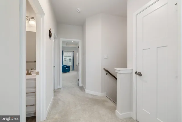 a spacious bedroom with a bed and a lamp