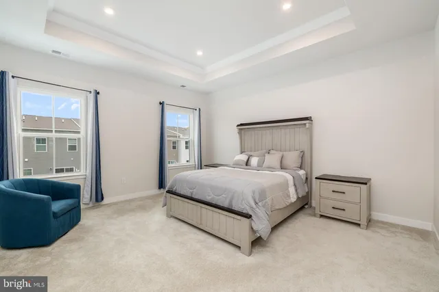 a spacious bedroom with a bed and a couch