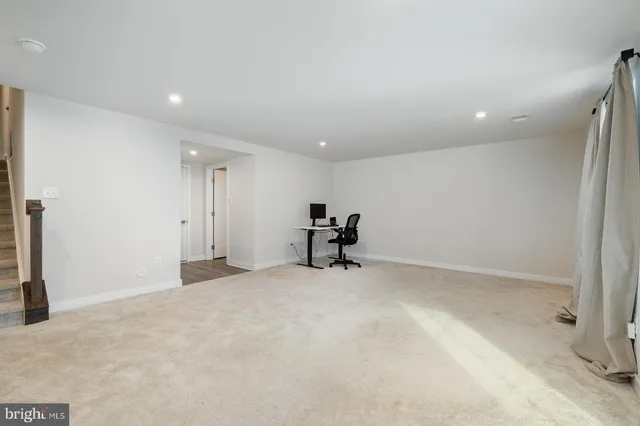 a view of workspace with furniture and staircase