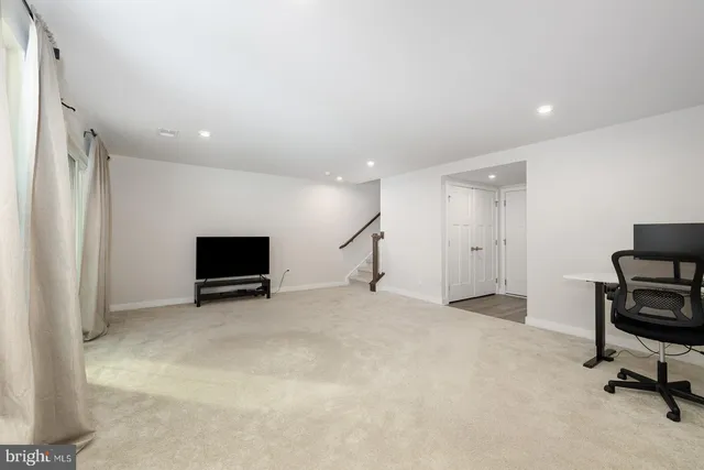 a view of an empty room with a fireplace