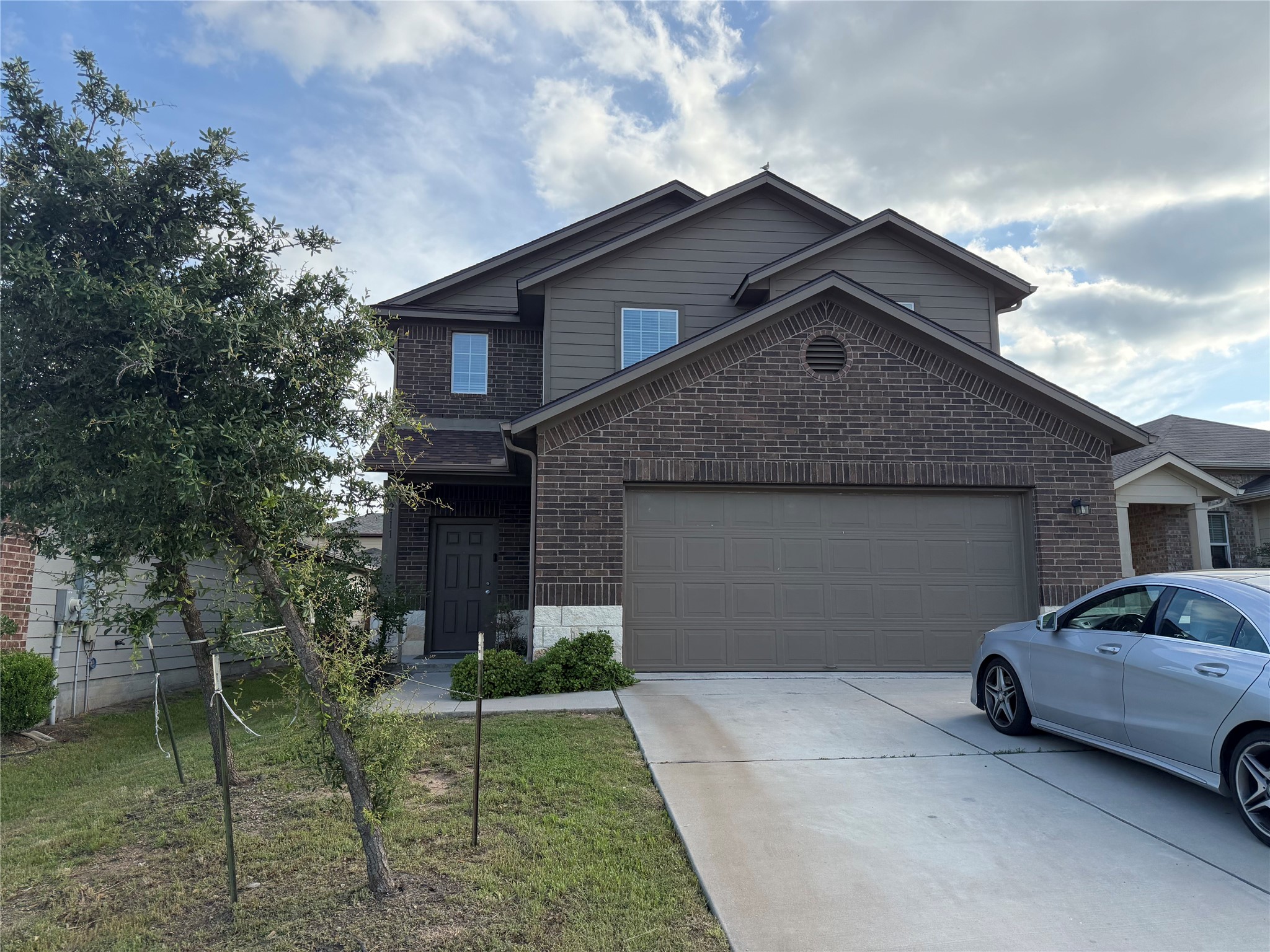 12111 Riprap Drive Manor, TX 78653 - Photo 1 of 14 a front view of a house with garden