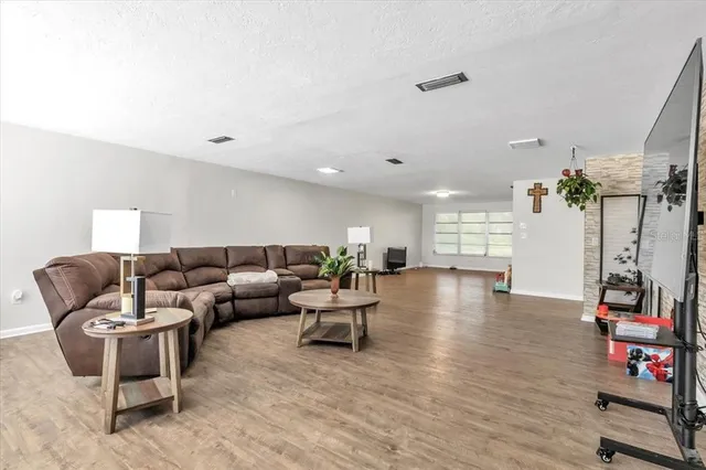 a bedroom with a bed and a flat tv screen on wall