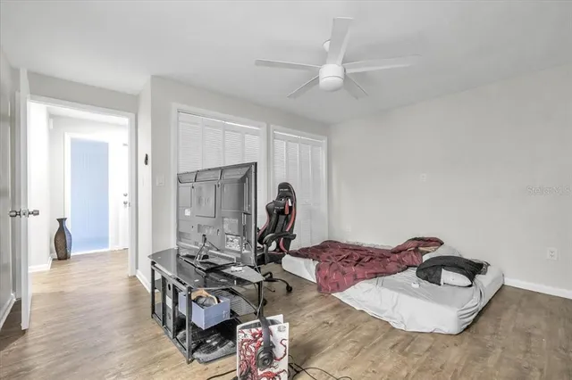 a living room with furniture a flat screen tv and a large window