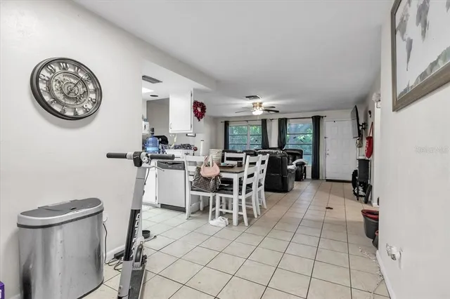 a bedroom with a bed a dresser and flat screen tv