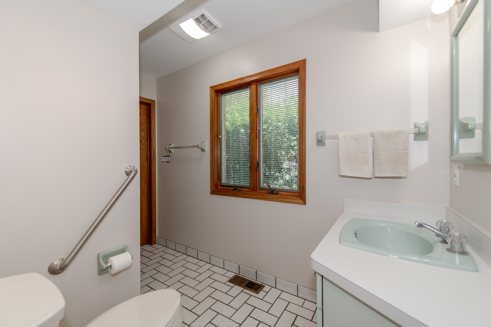 717 Westridge Road Joliet, IL 60431 - Photo 47 of 68 a bathroom with a sink a toilet and a mirror