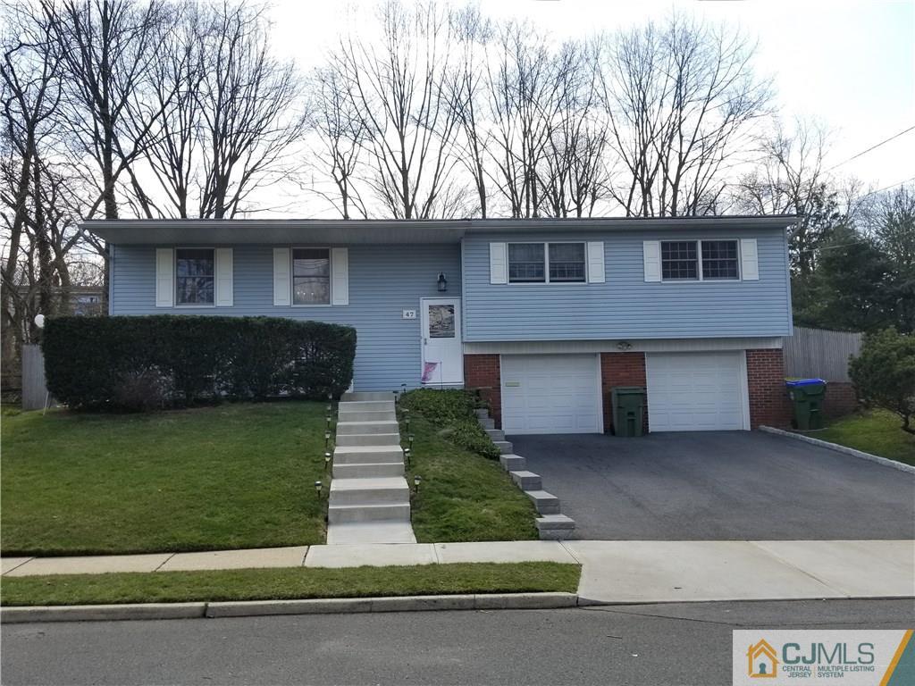 47 Harmon Road Edison, NJ 08837 - Photo 1 of 24 a front view of a house with a garden