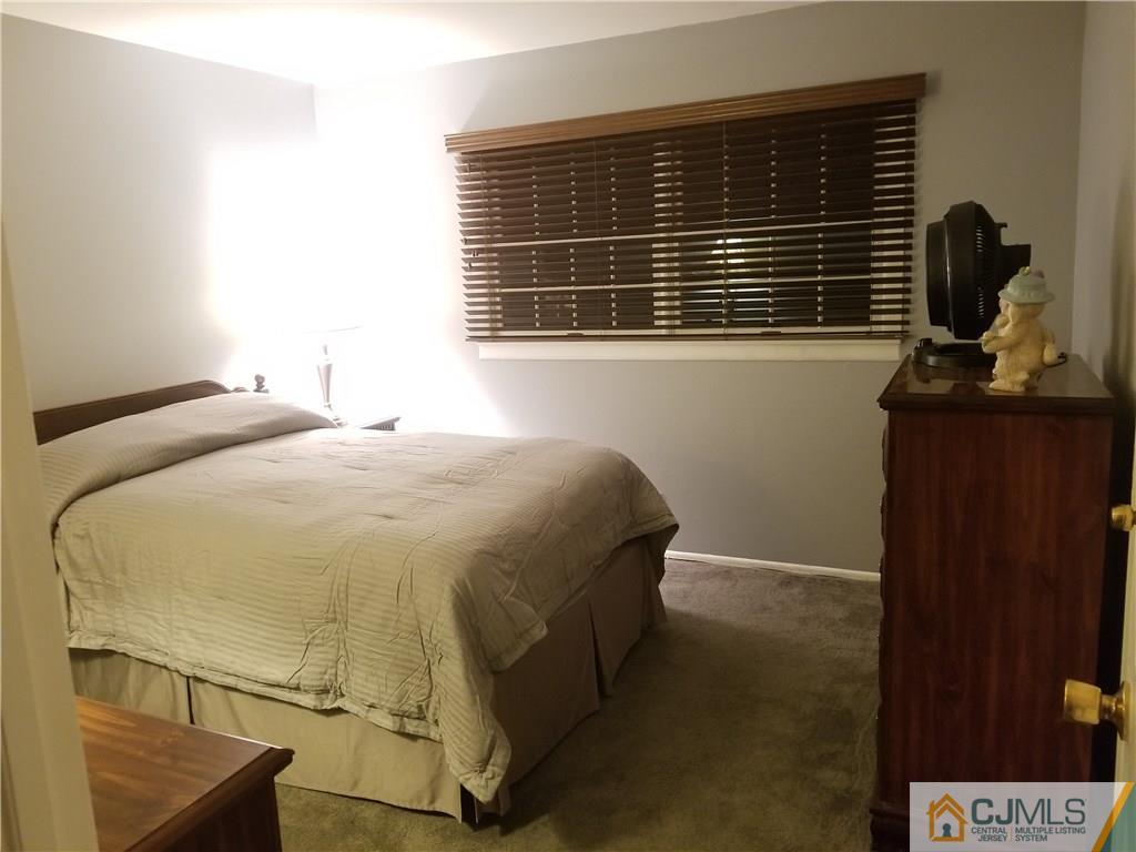 47 Harmon Road Edison, NJ 08837 - Photo 11 of 24 a bedroom with a bed and a window