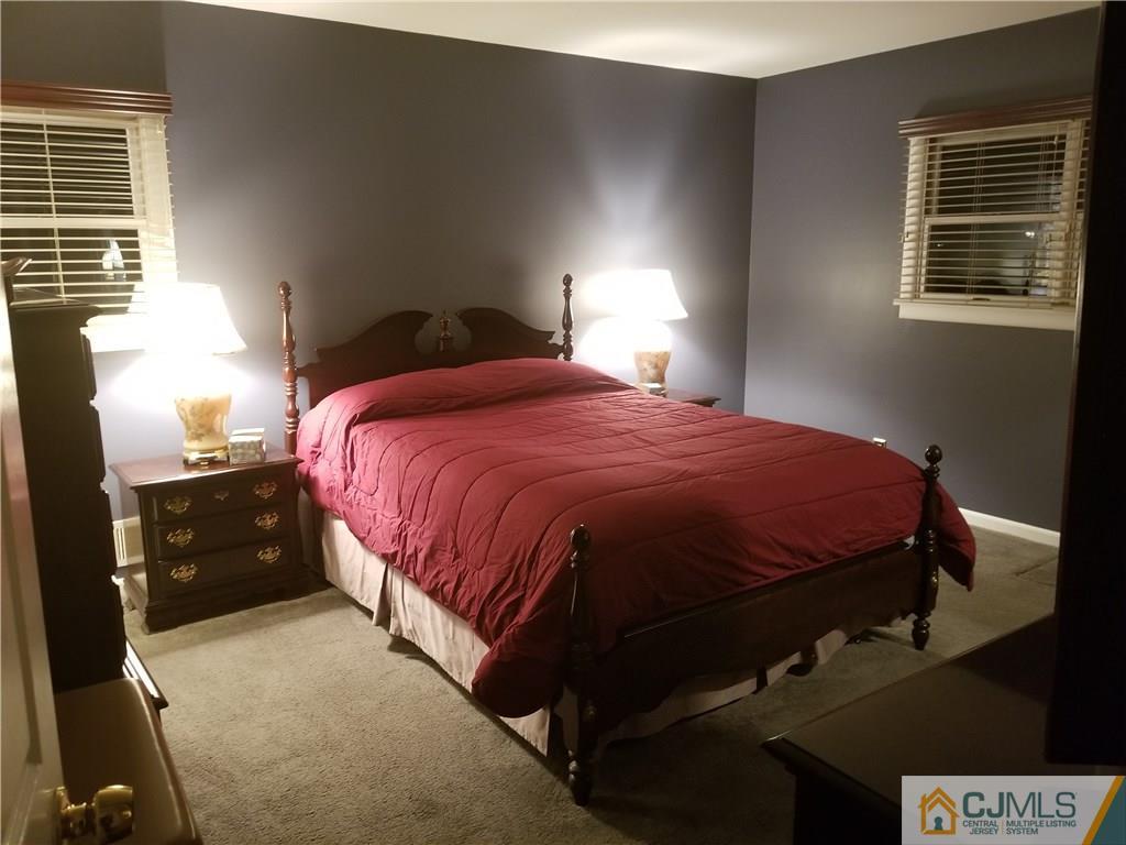47 Harmon Road Edison, NJ 08837 - Photo 12 of 24 a bedroom with a bed and a lamp