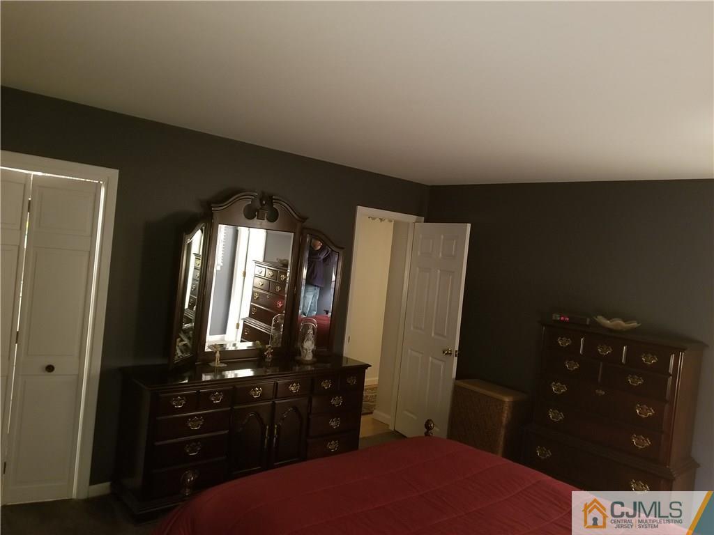 47 Harmon Road Edison, NJ 08837 - Photo 13 of 24 a bedroom with a bed and a dresser