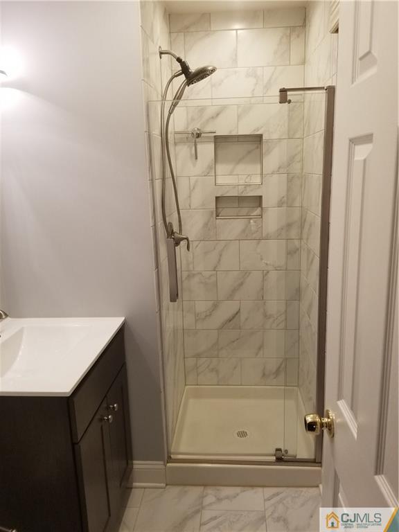 47 Harmon Road Edison, NJ 08837 - Photo 15 of 24 a bathroom with a shower and a sink