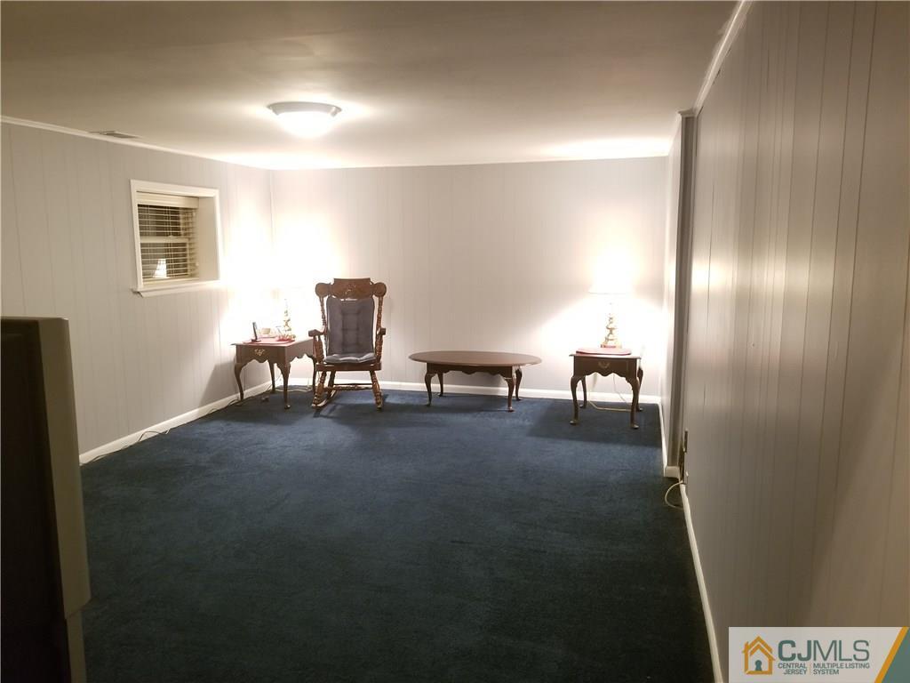 47 Harmon Road Edison, NJ 08837 - Photo 17 of 24 a living room with furniture and a table