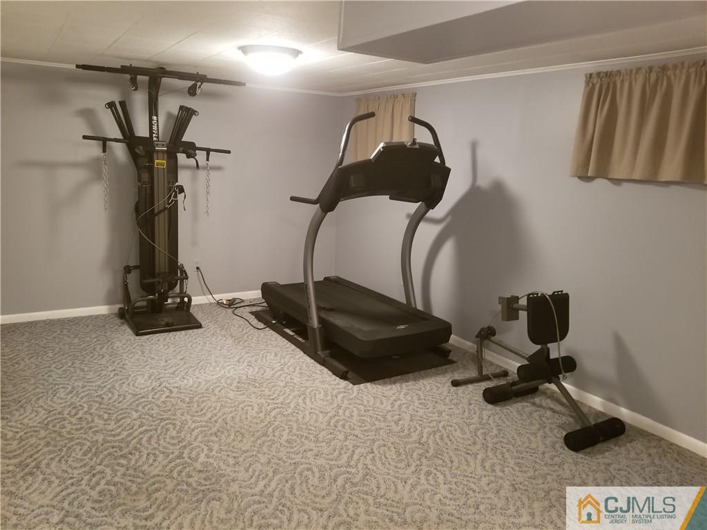 47 Harmon Road Edison, NJ 08837 - Photo 20 of 24 a room with gym equipment and a rug