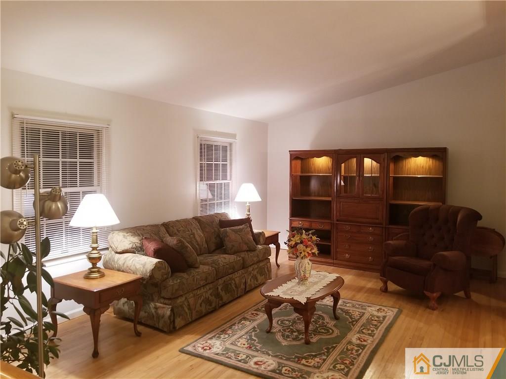 47 Harmon Road Edison, NJ 08837 - Photo 3 of 24 a living room with furniture and a lamp
