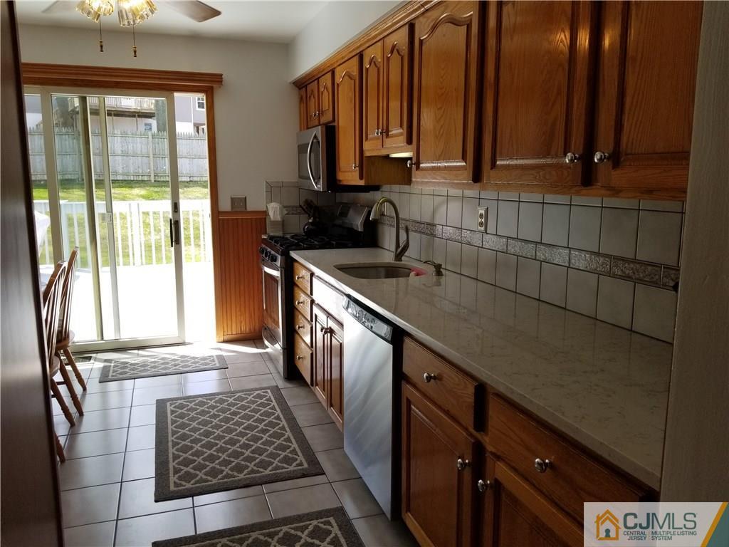 47 Harmon Road Edison, NJ 08837 - Photo 8 of 24 a kitchen with a sink a counter top space and cabinets