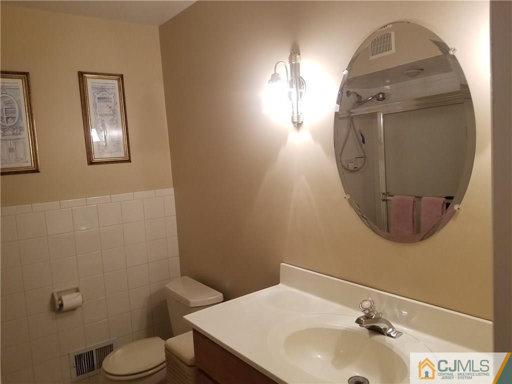 47 Harmon Road Edison, NJ 08837 - Photo 9 of 24 a bathroom with a sink toilet and mirror