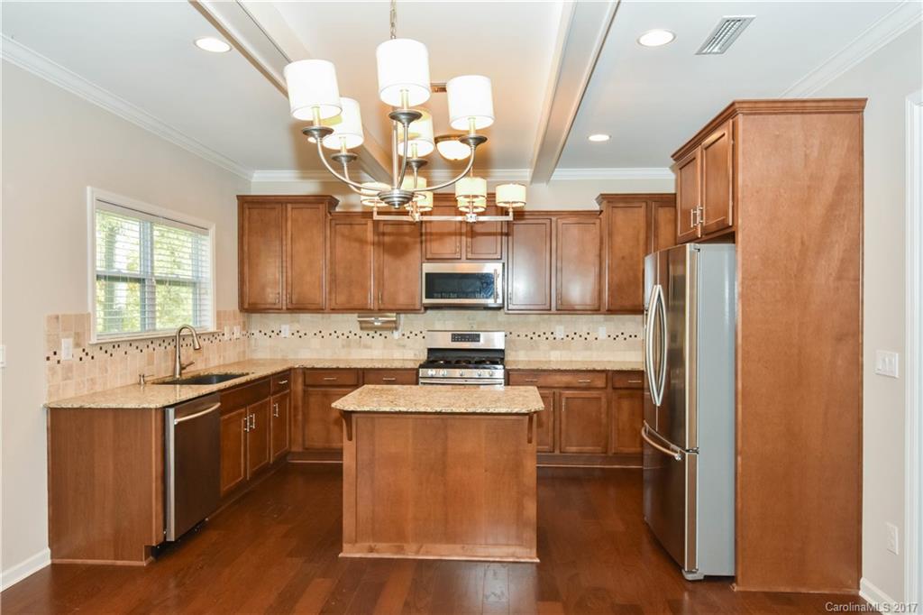 7079 Meyer Road Fort Mill, SC 29715 - Photo 6 of 20 a kitchen with stainless steel appliances granite countertop a sink stove and refrigerator