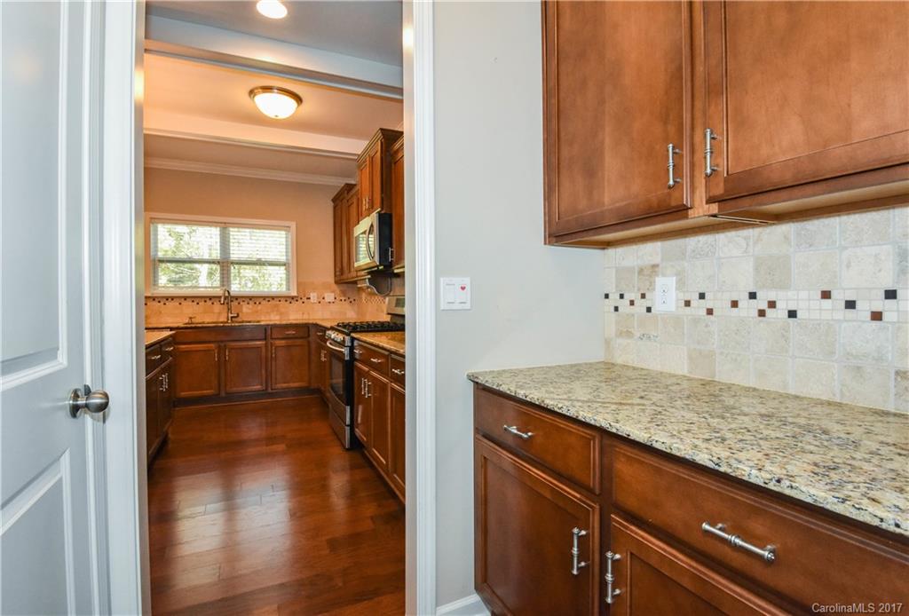 7079 Meyer Road Fort Mill, SC 29715 - Photo 7 of 20 a kitchen with a sink a stove and cabinets