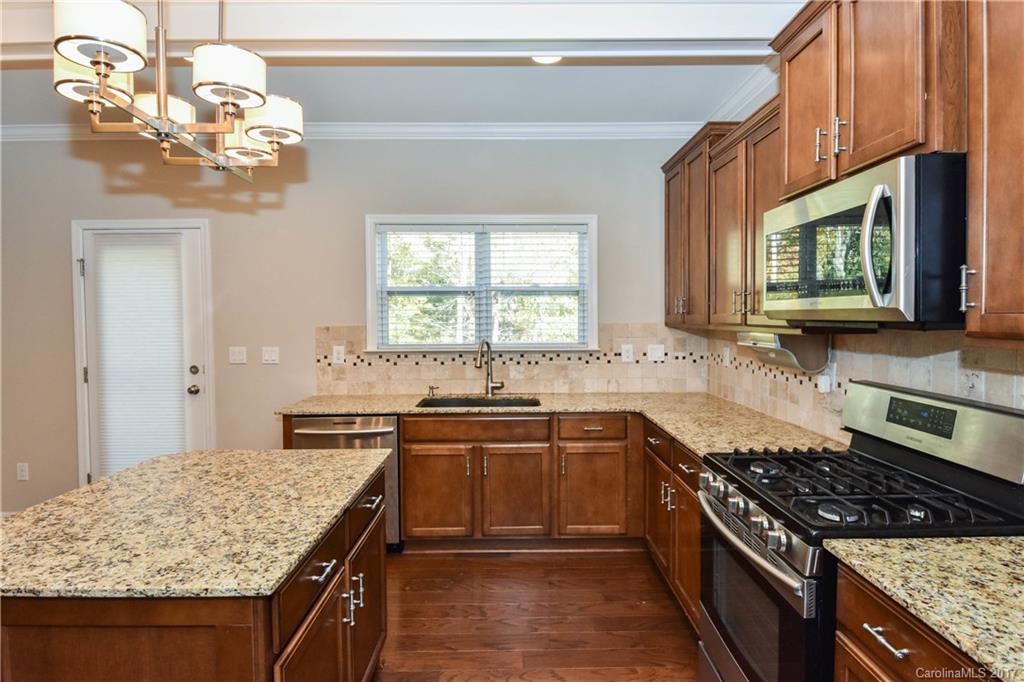 7079 Meyer Road Fort Mill, SC 29715 - Photo 8 of 20 a kitchen with a stove a sink and a microwave