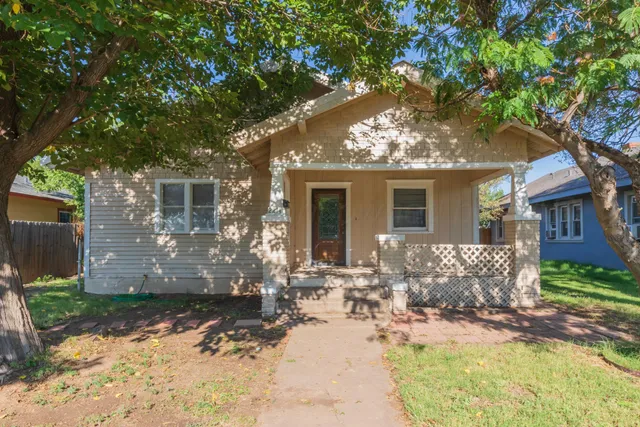 front view of a house with a tree
