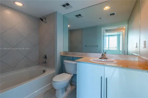 a bathroom with a sink a toilet and bathtub