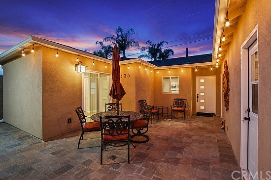 135 East Everett Place Orange, CA 92867 - Photo 1 of 1 a view of a patio with table and chairs and potted plants
