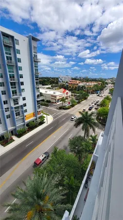 a view of a balcony with two plants and garden