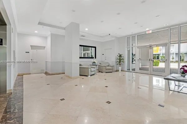 a large white kitchen with a large window