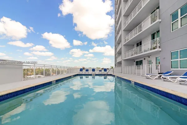 a view of a swimming pool with an outdoor seating