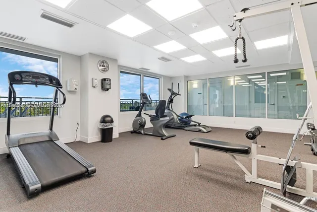 a room with gym equipment and large mirror