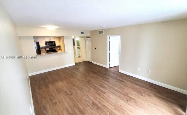 a view of a room with wooden floor