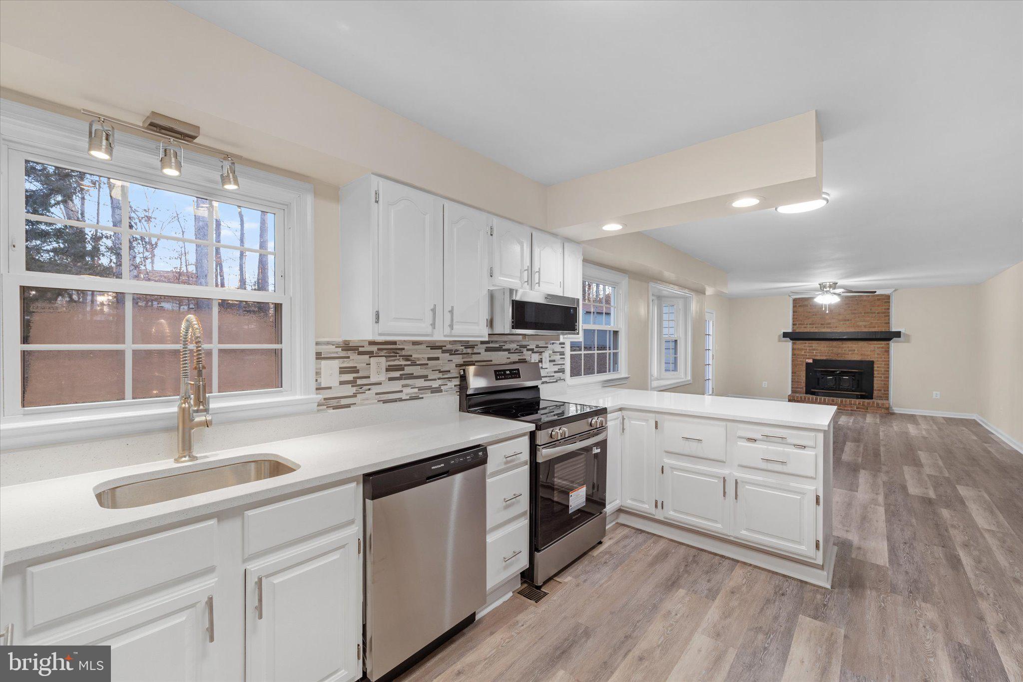 8016 Stillbrooke Road Manassas, VA 20112 - Photo 4 of 41 a kitchen with granite countertop a sink stainless steel appliances and cabinets