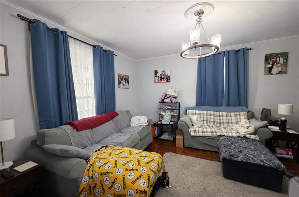 329 New Castle Street Slippery Rock, PA 16057 - Photo 3 of 27 a bedroom with furniture and a chandelier