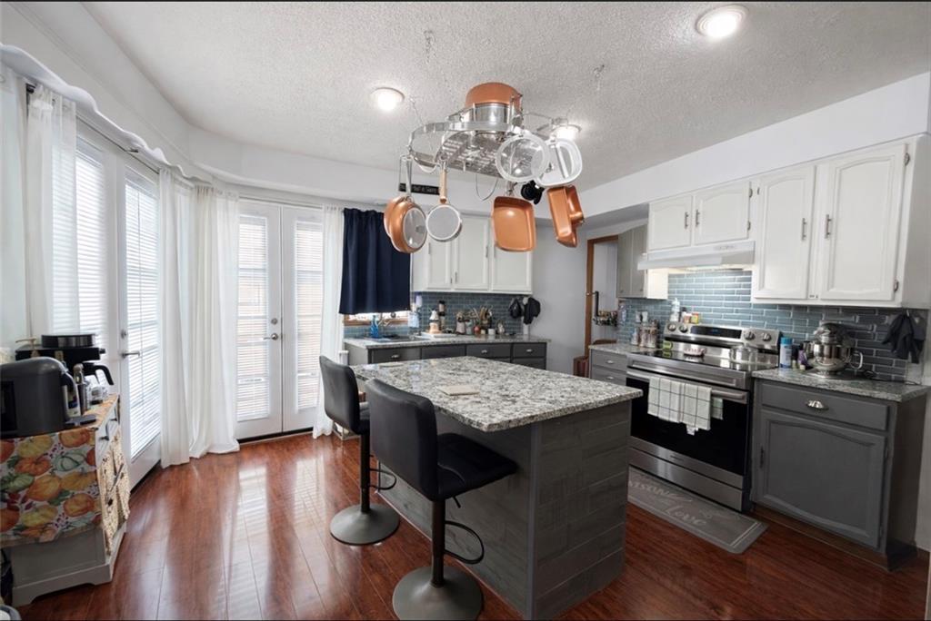 329 New Castle Street Slippery Rock, PA 16057 - Photo 4 of 27 a kitchen with stainless steel appliances granite countertop a lot of counter space and wooden floor