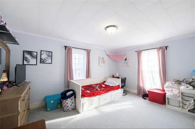 a bedroom with furniture and a window