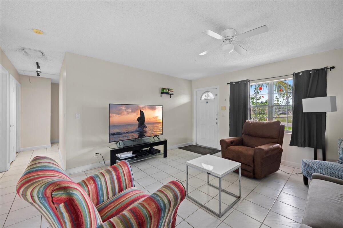 19309 Carolina Circle Boca Raton, FL 33434 - Photo 11 of 30 a living room with furniture and a flat screen tv