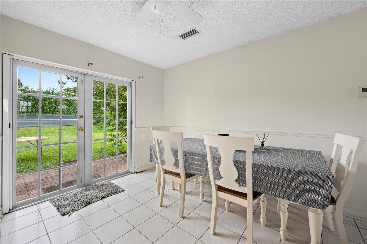 19309 Carolina Circle Boca Raton, FL 33434 - Photo 12 of 30 a view of a dining room with furniture large windows and wooden floor