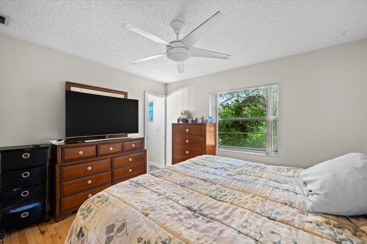 19309 Carolina Circle Boca Raton, FL 33434 - Photo 17 of 30 a bedroom with a bed and a flat screen tv