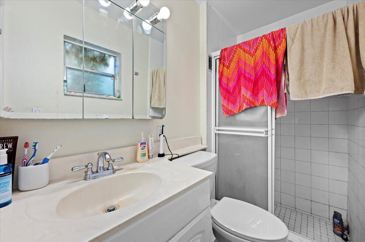 19309 Carolina Circle Boca Raton, FL 33434 - Photo 19 of 30 a bathroom with a sink vanity mirror and toilet