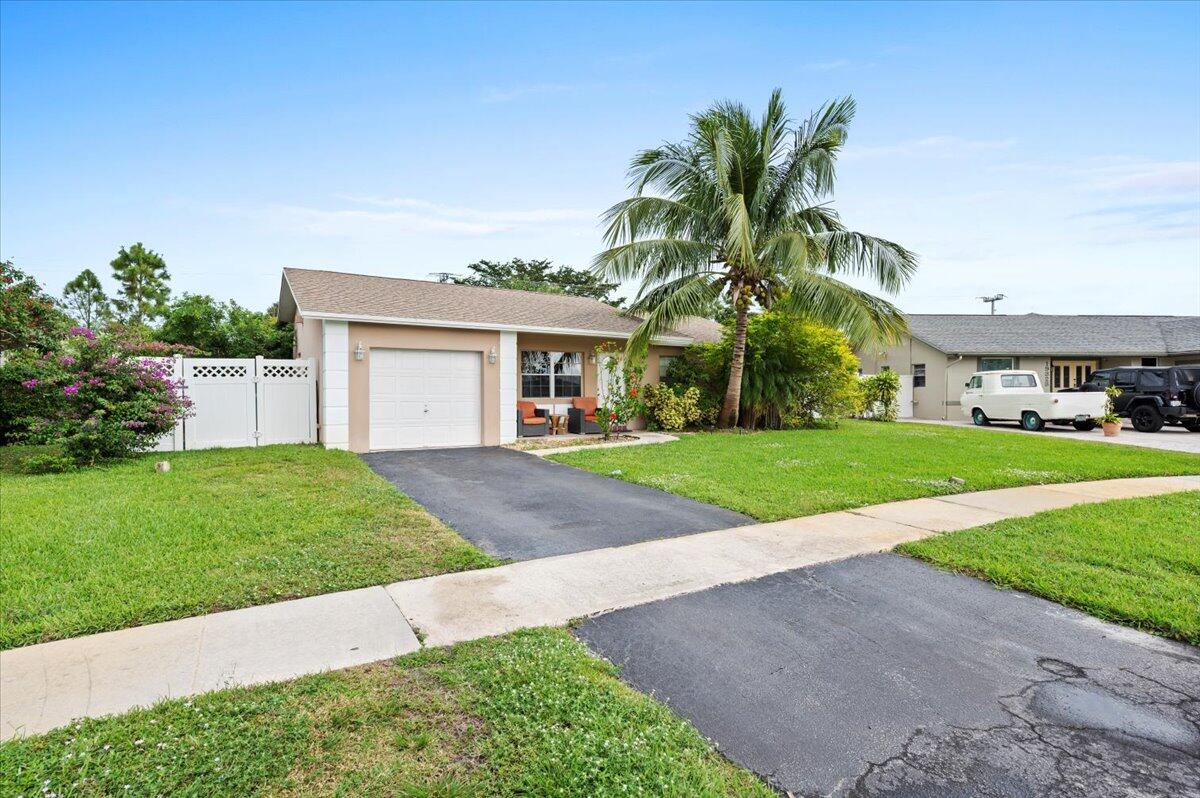 19309 Carolina Circle Boca Raton, FL 33434 - Photo 2 of 30 a front view of house with yard and green space