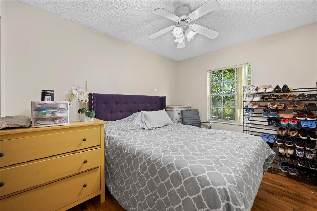 19309 Carolina Circle Boca Raton, FL 33434 - Photo 22 of 30 a bedroom with a bed and a chandelier