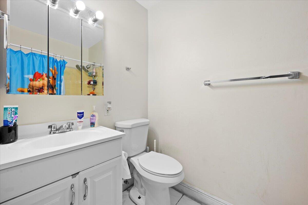 19309 Carolina Circle Boca Raton, FL 33434 - Photo 23 of 30 a bathroom with a sink mirror vanity and toilet